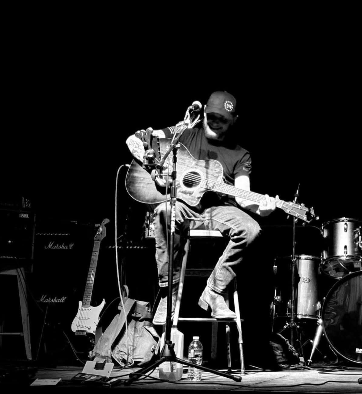 Robbie performing with his acoustic guitar