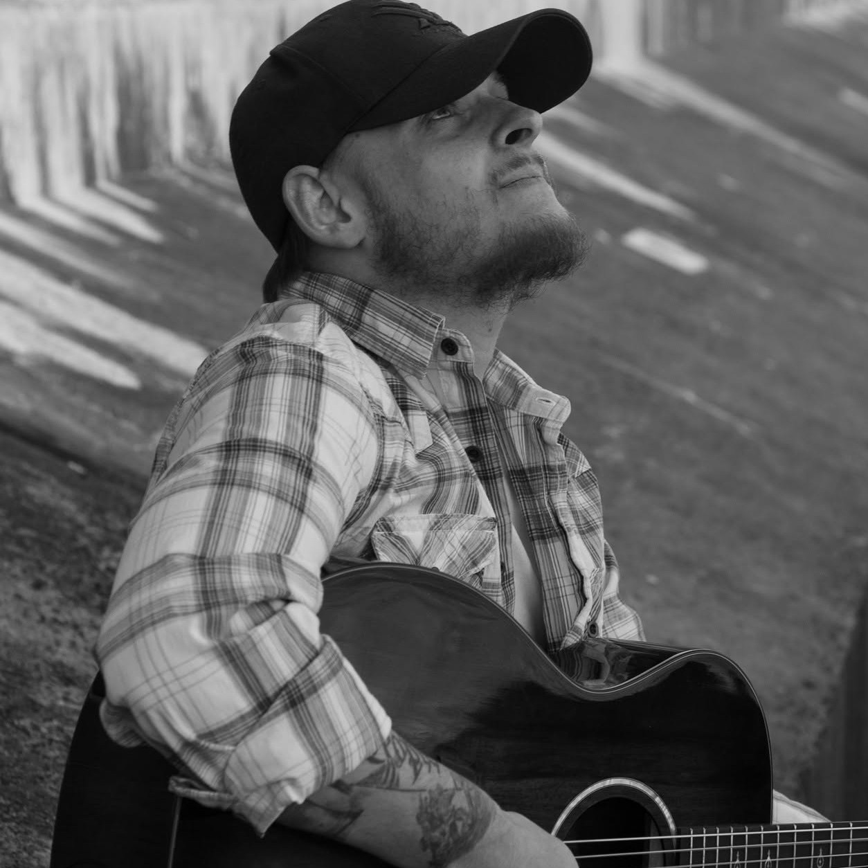 Robbie with his guitar in black and white
